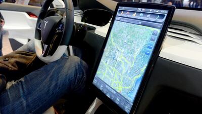 The Tesla Model X computer screen mounted on the dashboard is introduced at the Detroit Auto Show last year. Stan Honda/ AFP
