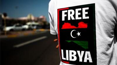 But ambassador tells crowd outside the Abu Dhabi embassy that although he is 'with the people', he has not stepped down, nor will he lower the colours below half-staff.