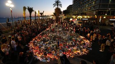 People gather at a makeshift memorial on the Promenade des Anglais in Nice on July 17, 2016. Valery Hache / AFP