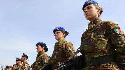 Italian soldiers stand to attention during a change of command ceremony at an Italian military camp near Herat airport in February. Aref Karimi / AFP