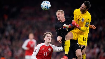 Denmark's Andreas Skov Olsen, left, and Austria's Martin Hinteregger and goalkeeper Daniel Bachmann battle for the ball. AP