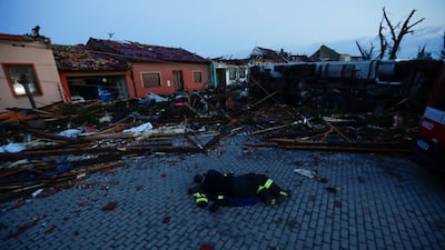 A member of the emergency services rests amid the debris from a tornado that struck the village of Moravska Nova Ves in the Czech Republic. Reuters