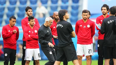 Egypt's head coach Hector Cuper, centre left, leads his team's training session. Tolga Bozoglu / EPA