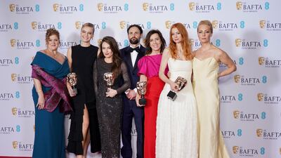 Navalny producers Melanie Miller, left, Shane Boris, centre, Diane Becker, third right, and Odessa Rae, second right, with the Baftas in London. Getty