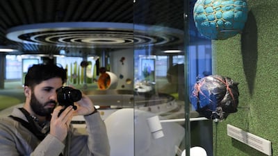 A visitor takes a pictures of the “Juala Balls” during a press visit on January 12, 2016 at the new museum dedicated to Fifa in Zurich. The Fifa World Football Museum will open its doors on February 28, 2016 allowing the scandal-tainted world football body to show off artefacts from the sport’s rich heritage. Fabrice Coffrini / AFP