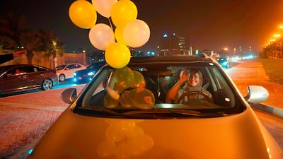 A Saudi woman and her friends celebrate her first time driving on a main street of Khobar City on her way to Bahrain on June 24, the day Saudi Arabia lifted its ban on women driving. AFP