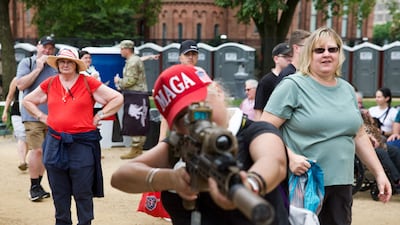 A Maga supporter holds an unloaded display gun during the Army 250th Anniversary Parade on the National Mall on June 14. AFP