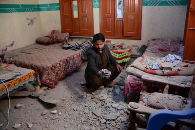 In this picture taken on March 6, 2019, Pakistani Kashmiri resident Abdul Shakoor holds a piece of mortar shell fired by cross border Indian troops that hit and damaged his house in Dhanna village near the Line of Control (LoC) in Pakistan-administered Kashmir. Photo: AFP