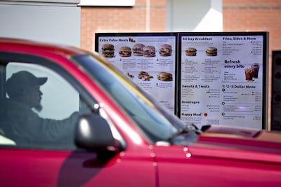 A customer views a digital menu at a drive-thru outside a McDonald's restaurant in the US. Bloomberg