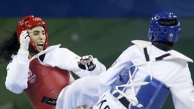 Hwang Kyungseon of South Korea and Sheikha Maitha Almaktoum of United Arab Emirates, left, fight during their women's 67kg preliminary round of 16 taekwondo match.