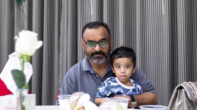 A father and his son attend the iftar