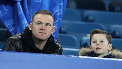 Manchester United’s Wayne Rooney observes the team’s training session on Monday in Wolfsburg with his son Kai. Lindsey Parnaby / AFP
