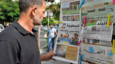 A man reads a paper at a Beirut newsstand. EPA-EFE/Wael Hamzeh