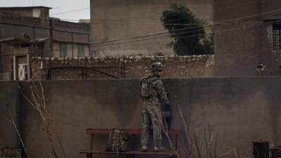 A US Army soldier stands guard during Christmas Day mass at Mar Hanna Church in Qaraqosh, Mosul, in 2016