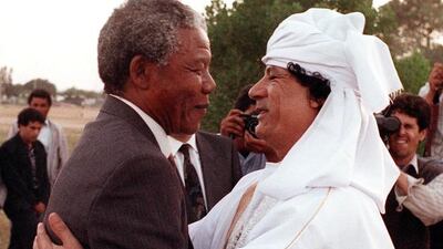 Then South African anti-apartheid leader and African National Congress member Nelson Mandela and Libyan leader Muammar Qaddafi hug upon Mandela's arrival to Tripoli in May, 1990.