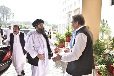Pakistan Foreign Minister Shah Mahmood Qureshi, right, greets Taliban co-founder Abdul Ghani Baradar during their meeting in Islamabad in 2019. EPA