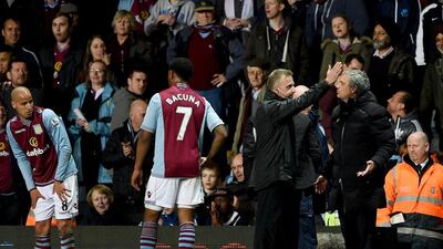 Chelsea manager Jose Mourinho, right, appeals to fourth official Jonathan Moss as he is sent off during the Premier League match between Aston Villa and Chelsea at Villa Park on March 15, 2014. Mourinho says referee Chris Foy's decisions against Chelsea will hurt their title chances. Michael Regan / Getty Images