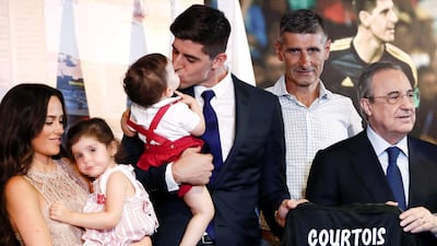 Thibaut Courtois, centre, kisses one of his children upon being presented as a Real Madrid player. EPA