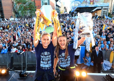 Manchester City's Steph Houghton, left, and Georgia Stanway celebrate with the Women's FA Cup and Continental Cup trophies during the Manchester City Teams Celebration Parade on on May 20, 2019. Getty Images