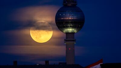 The full Hunters Supermoon rises next to the television tower in Berlin, Germany, Thursday, Oct. 17, 2024. (AP Photo / Michael Probst)