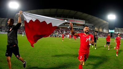 Players hold up a Bahrain flag. AFP
