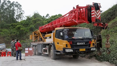 A crane arrives at Lu village to aid search and rescue workers. Reuters
