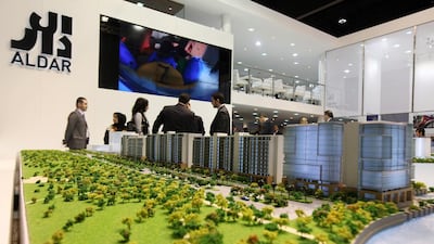 Visitors look at a scaled version of Aldar's Al Zeina project during the 2013 Ctiyscape in Abu Dhabi. Pawan Singh / The National