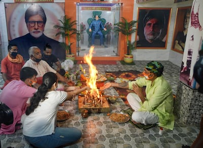 Fans of Bollywood actor Amitabh Bachchan offer a prayer for his health in Kolkata, eastern India, on 12 July 2020 after he tested positive for coronavirus. He has since recovered. EPA