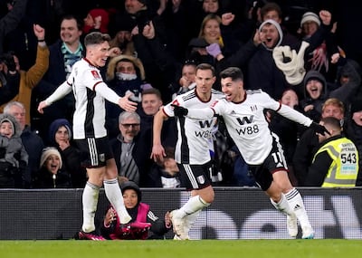 Fulham's Manor Solomon, right, celebrates scoring their side's second goal. PA