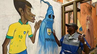 A peddler smiles as he sees a graffiti depicting Brazil's footballer Neymar kissing goodbye the ghost of the "Maracanazo" (the defeat of Brazil by the winning Uruguayan team in the 1960 world cup) in a suburb of Rio de Janeiro. Vanderlei Almeida / AFP