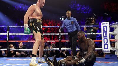 Tyson Fury knocks down Deontay Wilder in the fifth round during their WBC heavyweight title fight at the MGM Grand in Las Vegas on Saturday, February 22. Wilder's team threw in the towel in the seventh round. AFP