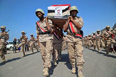 Fighters loyal to Yemen's Saudi-backed government march during a mass funeral for fellow combatants. AFP