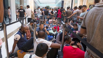 Apple customers queue through the night at The Dubai Mall to be one of the first to get the new Apple devices. Leslie Pableo / The National