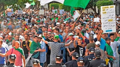 Algerian protesters face riot police during a demonstration against the ruling class in the capital Algiers. AFP / RYAD KRAMDI