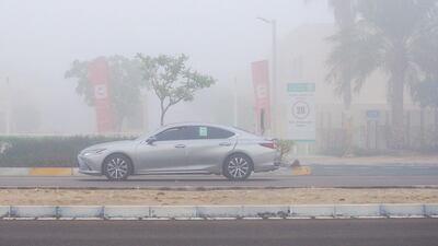 A car drives through the fog at Khalifa City, Abu Dhabi. Victor Besa / The National