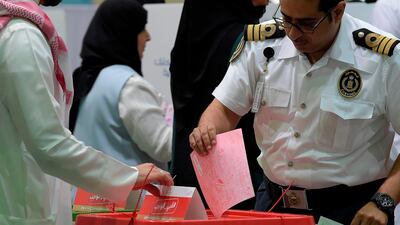 A Bahraini voter casts his ballot. AFP