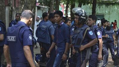 Bangladeshi police detain a suspected militant following an attack near the country's largest Eid prayer rally in Kishoreganj district on July 7, 2016. APF / STR