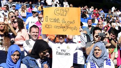 A fan of Real Madrid holds up a sign supporting Cristiano Ronaldo on Sunday during the team's match against Granada at the Santiago Bernabeu. Gerard Julien / AFP