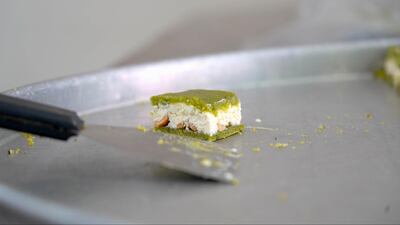 Daoukiye consists of consists of fluffy cream and cashews, sandwiched between two layers of emerald-green pistachio paste. Mahmoud Rida / The National