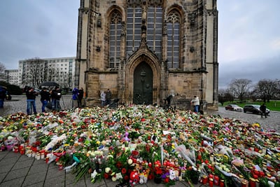 Flowers and candles in tribute to the victims are placed outside the Johanniskirche, near the site of a car-ramming attack on a Christmas market in Magdeburg, eastern Germany, last December. AFP