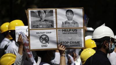 School teachers hold placards calling for the release of detained Myanmar State Counselor Aung San Suu Kyi (L) and President Win Myint (R) during a protest against the military coup outside the Chinese Embassy in Yangon, Myanmar. EPA