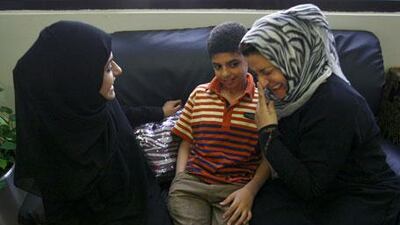 Al Anood al Abdool, a volunteer at the Friends of Cancer Patients Centre of Sharjah, chats to Mustafa Jabar, 11, who suffers from non-Hodgkin's lymphoma as well as hepatitis B and C, and his mother Nabela al Badri, who is also a volunteer at the centre, which has been treating her son for the past four years. Among other things, the volunteers make sure there is a friendly face and emotional support for patients and their families.