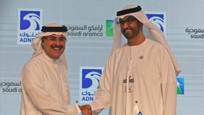 Saudi Aramco President Amin al-Nasser, left, shakes hands with Dr Sultan Ahmed Al Jaber, UAE Minister of State and ADNOC Group CEO after signing their framework agreement at Adipec. AP