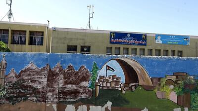 Graffiti is seen on the exterior walls of a closed government school in Amman. EPA