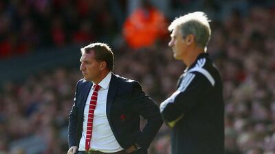 Liverpool manager Brendan Rodgers, far, looks on during his side's win over West Bromwich Albion in the English Premier League on Saturday at Anfield. Clive Brunskill / Getty Images / October 4, 2014