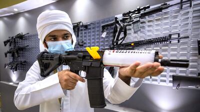 A man inspects a weapon at the Bynuna stall at Adihex. Victor Besa / The National