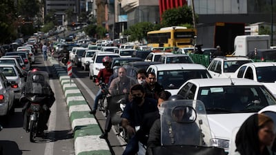 Iranians wear protective face masks ride on their motorbikes in a crowded at street, in Tehran, Iran. REUTERS