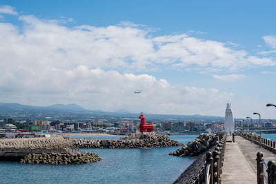 Horse-shaped lighthouse on the beach in Jeju Island. Getty Images