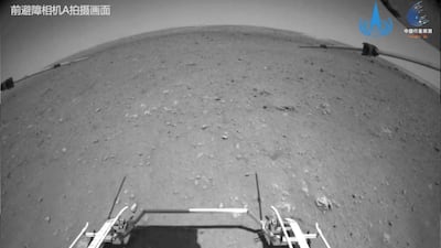 Chinese rover Zhurong drives down the ramp of the lander onto the surface of Mars, in this screenshot taken from a video released by China National Space Administration. Reuters
