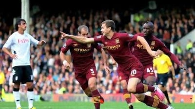 Edin Dzeko, the Manchester City forward, celebrates after scoring the winner against Fulham. Paul Gilham / Getty Images